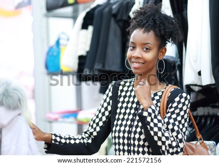 beautiful young african girl shopping in clothe\'s department