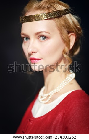 Very beautiful woman in medieval dress in studio look like a old time paynting looks like a queen