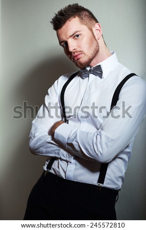Elegant young man with white shirt and suspenders