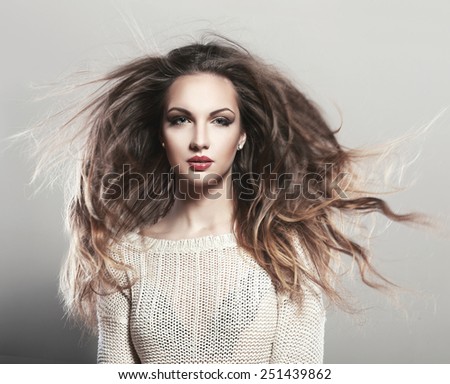 Portrait of a beautiful brunette girl with fluttering hair