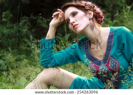 Young woman outdoors fashion portrait style Boho in the forest