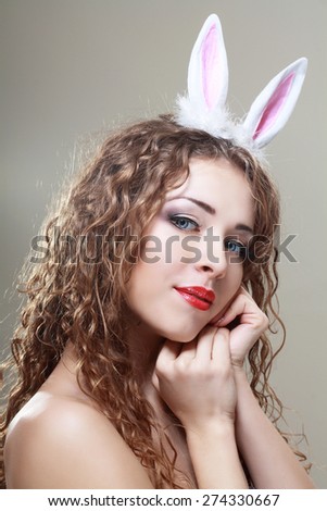 beautiful young woman wearing cute bunny ears looking to her side