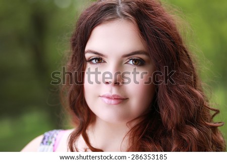 Portrait of a young beautiful woman with bridal hairstyle and makeup