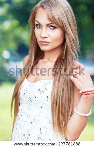 Woman White Summer Lace Dress, Young Girl Long Straight Hair, Fashion Model Posing over Green unfocused background