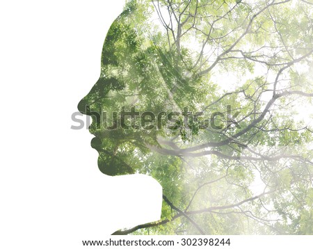 Double exposure portrait of attractive lady combined with photograph of tree. Be creative!