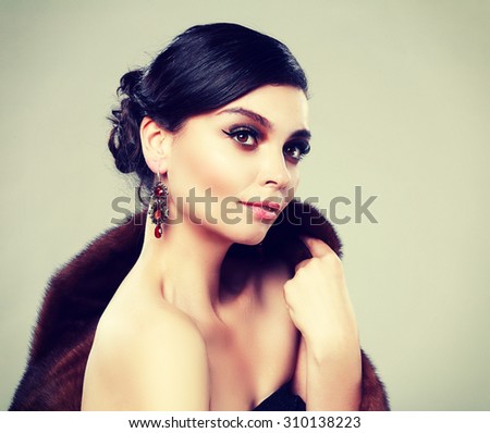 Beautiful woman with evening make-up. Jewelry and Beauty. Fashion photo Fashion retro toning.