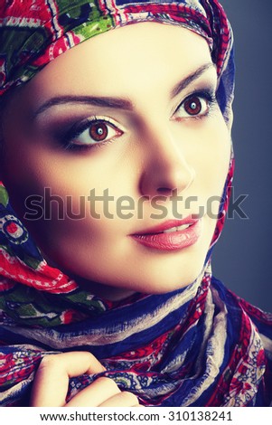 Beautiful Arabic woman wearing head scarf Fashion retro toning.