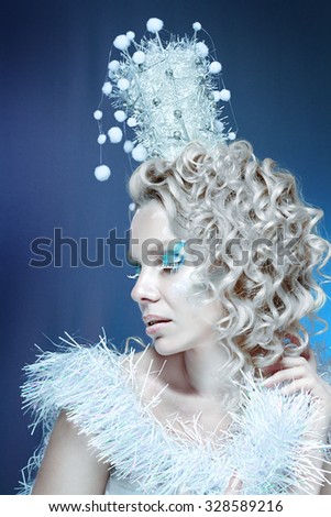 snow-queen. Young winter woman in creative image with silver blue artistic make-up and perfect hairstyle.