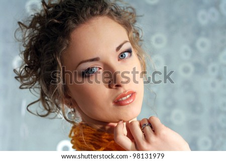 Beautiful Fashion Young Woman in Paper dress.Perfect Makeup. Orange thread lace. Blue background with copy-space