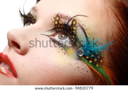 Gorgeous Young model beautiful women with perfect art make up and long false eyelashes made from feathers