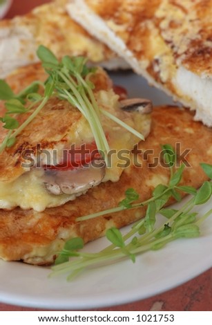 freshly cooked omelette with ham, cheese, tomato and mushrooms with toast