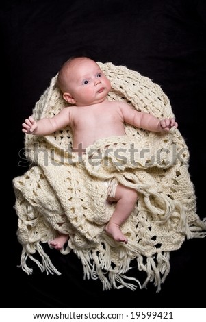 portrait of beautiful healthy baby girl wrapped in woolen shawl