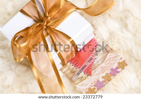 close of up of white gift box wrapped in ribbon - with \