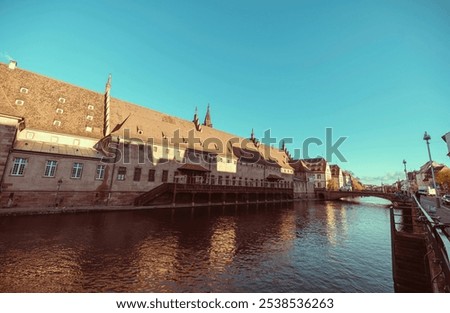 Similar – Image, Stock Photo Serene canal in old city district with aged buildings