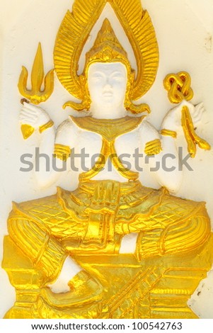 Armed goddess statue on the wall of the pagoda of Wat Thai.