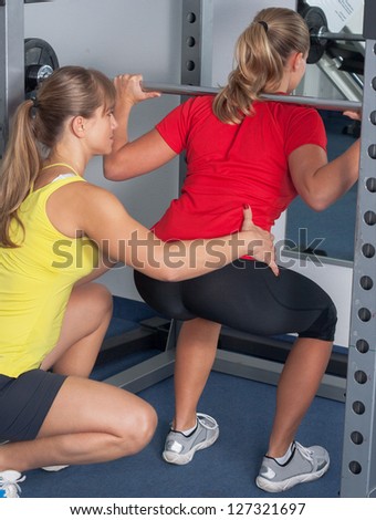 Two Blonde Women . Personal Trainer in a Gym . Two Women make sport