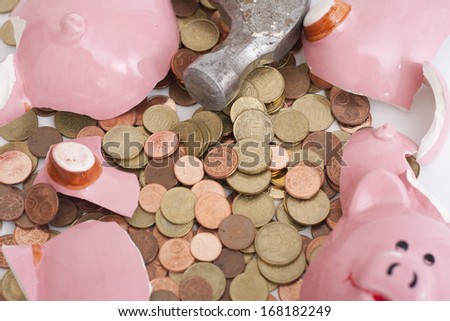 A broken Piggy bank with a hammer. Euro cents