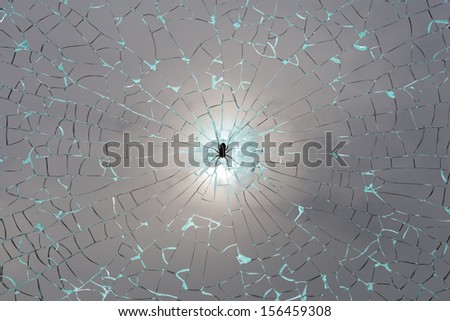 spiderweb of broken glass lines with a black spider and a soft shining through the fog, isolated with clipping paths
