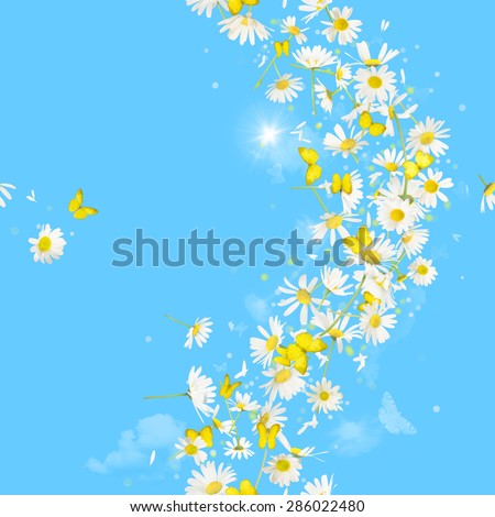 breeze of daisies and butterflies, with bokeh circles and a sunbeam, repeatable and isolated on absolute blue