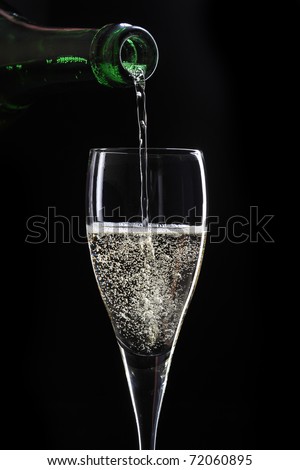 pouring champagne on black background