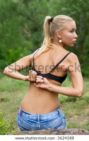 pretty blonde woman take off her black bra