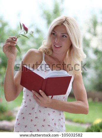 A young woman searches for the name of a flower in the directory
