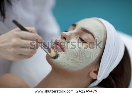 A young woman with a face pack.