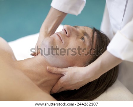 Man getting a facial . Face massage at day spa