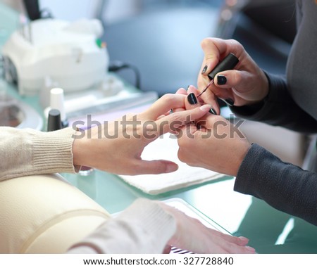 Manicure. Processing of nails by a nail file .Focus on the one hand and the customer master
