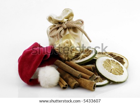 christmas composition with santa clause hat, gift bag, giftbox, cinnamonne and dried lemon