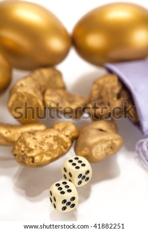 Nuggets of gold and a gold egg on a white background.