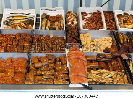 Variety of fresh and prepared fish presented at market stand