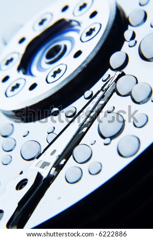 water droplets on the surface of a hard disk with read/write head, soft focus