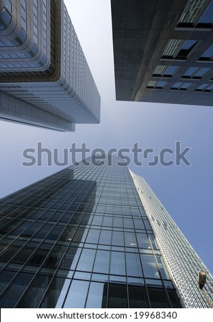 three tall office buildings seen from street level