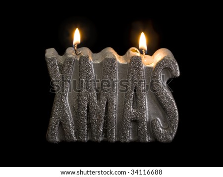 the word XMAS as silver glimmering candle on black background
