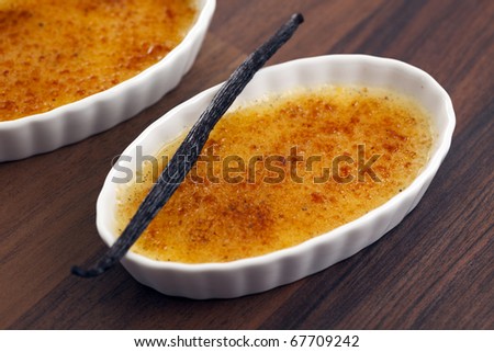 bowl of creme brulee with vanilla pod on top