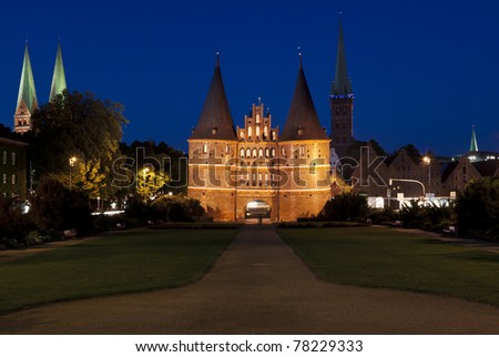 Night shot of Holsten gate at Lübeck with belltowers of Saint Mary and Saint Peter