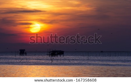 House of fishermen on the sea, sunset in Thailand.