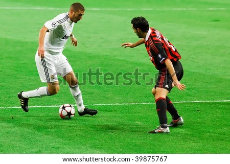MADRID – OCT 21: Real Madrid\'s Karim Benzema attempts to beat Gianluca Zambrotta during their 2-3 loss against AC Milan in Champions League group stage action on October 21, 2009 in Madrid, Spain.