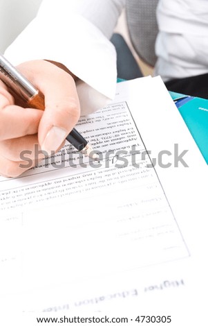 Business woman's hands and the pen.
