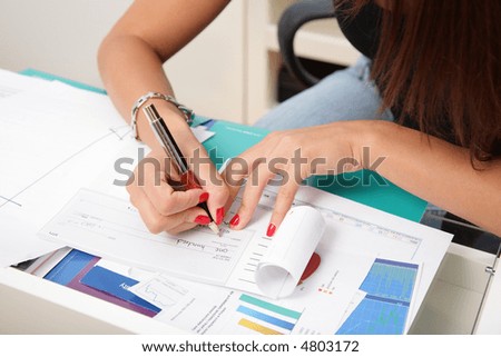Busines woman\'s hands and check book.