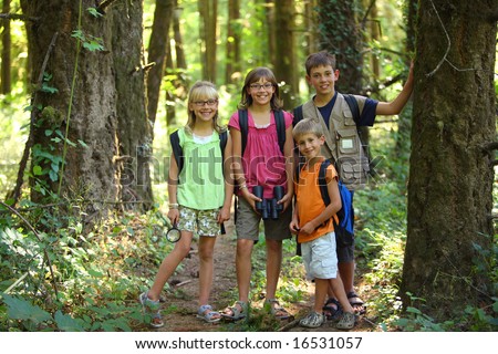 Four children in woods with camping gear