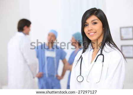 Portrait of nurse with medical personnel in background