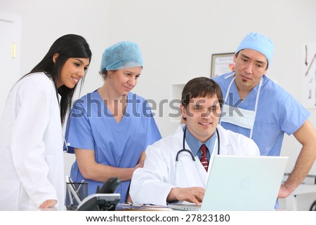 Medical personnel looking at laptop computer