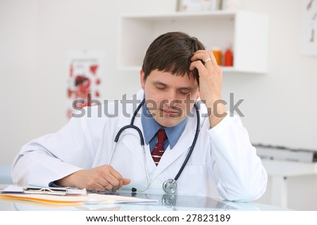 Stressed doctor at desk