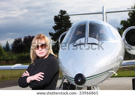 Businesswoman standing by corporate jet