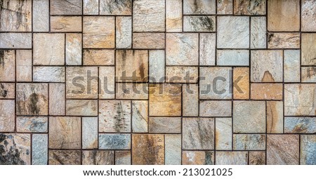 Grunge natural stone tiles wall for background and texture
