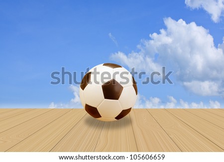 Soccer Ball on wood floor with a blue sky background