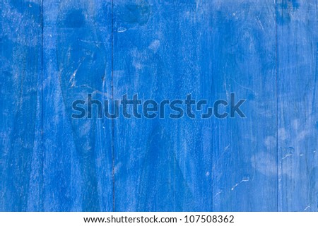 Cracked paint on blue wooden surface
