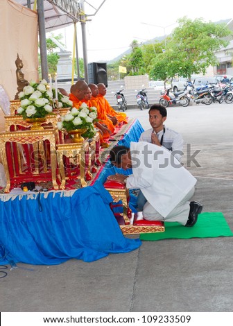 KO SAMUI, THAILAND - AUGUST 3  the district governor lead Thai Buddhist pray  to monks in The Buddhist Lent Day on August 3,2012 Samui island,Thailand